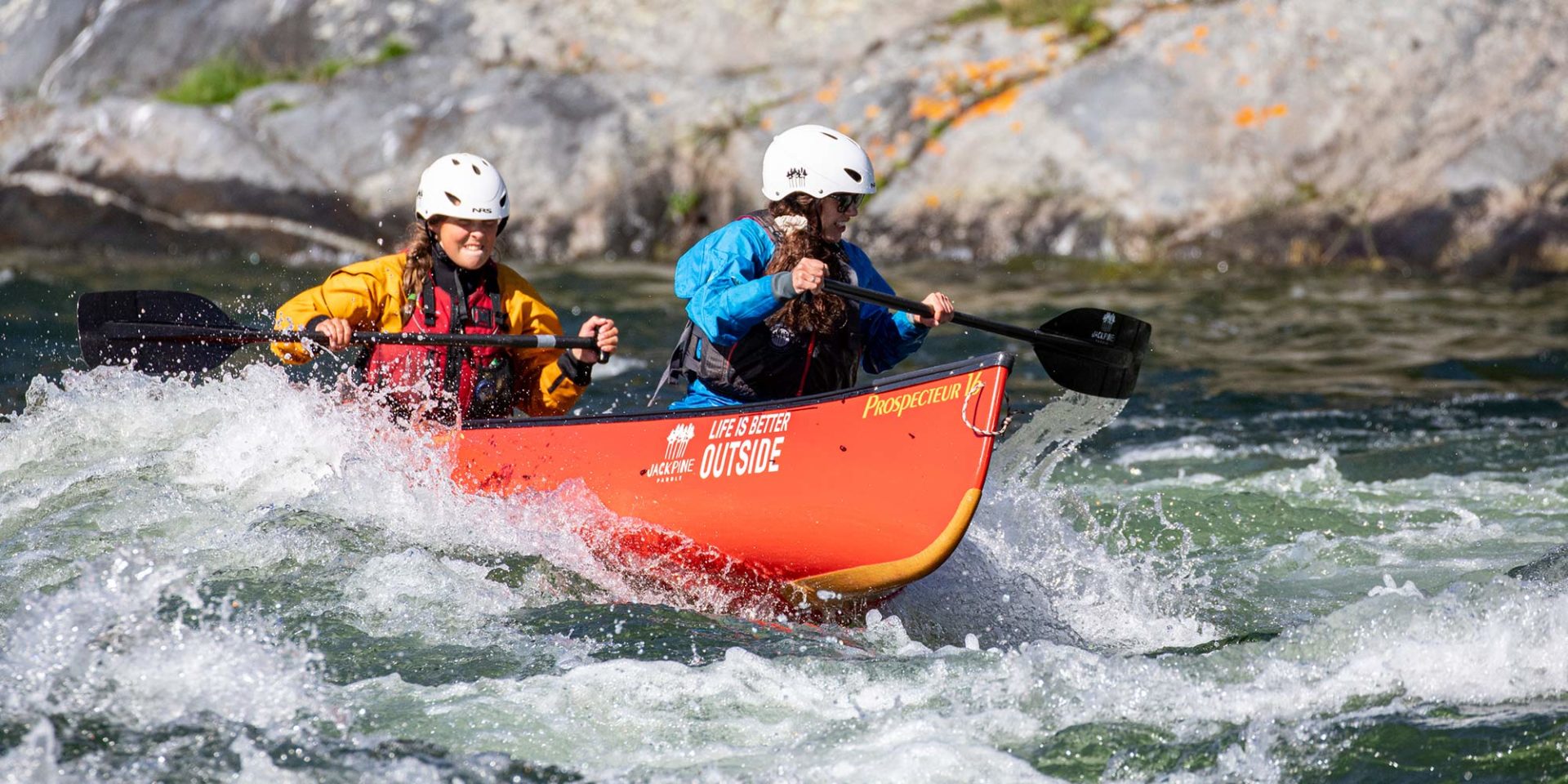 two people whitewater canoeing