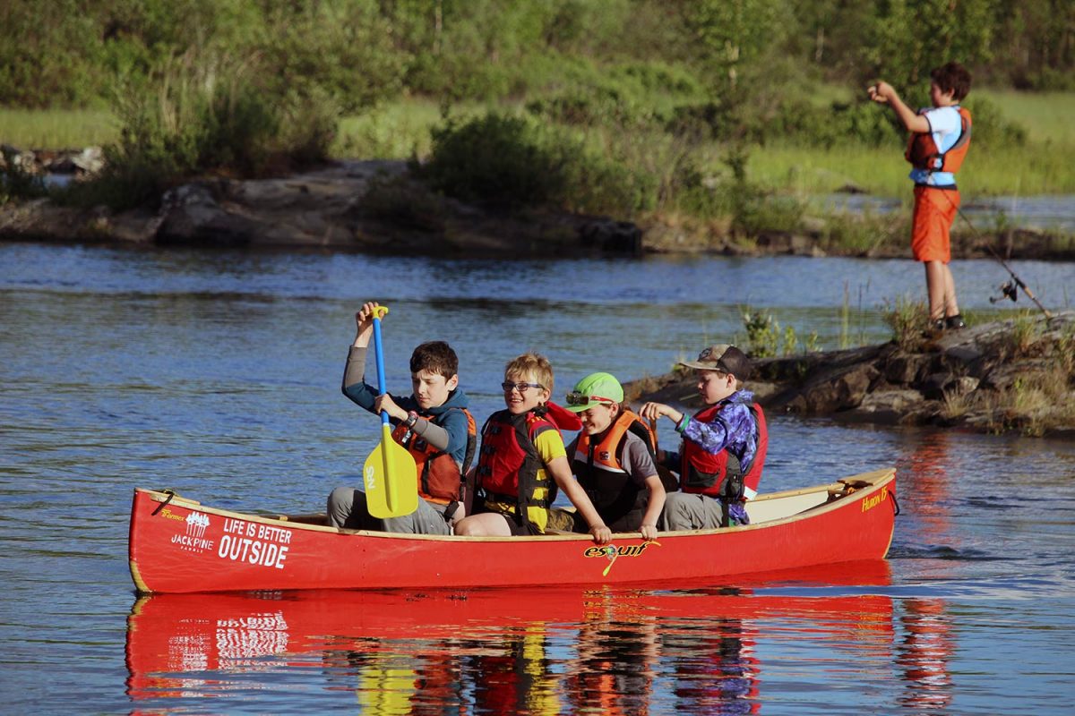 four kids in a canoe