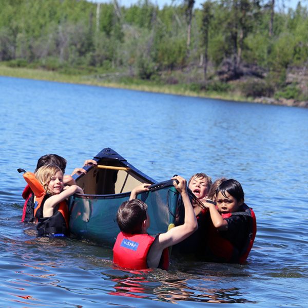 youth holding on to a paddle in the northwest territories