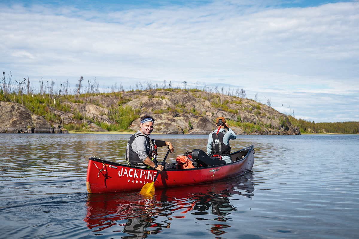 instructor paddling a canoe for a paddle canada camping course