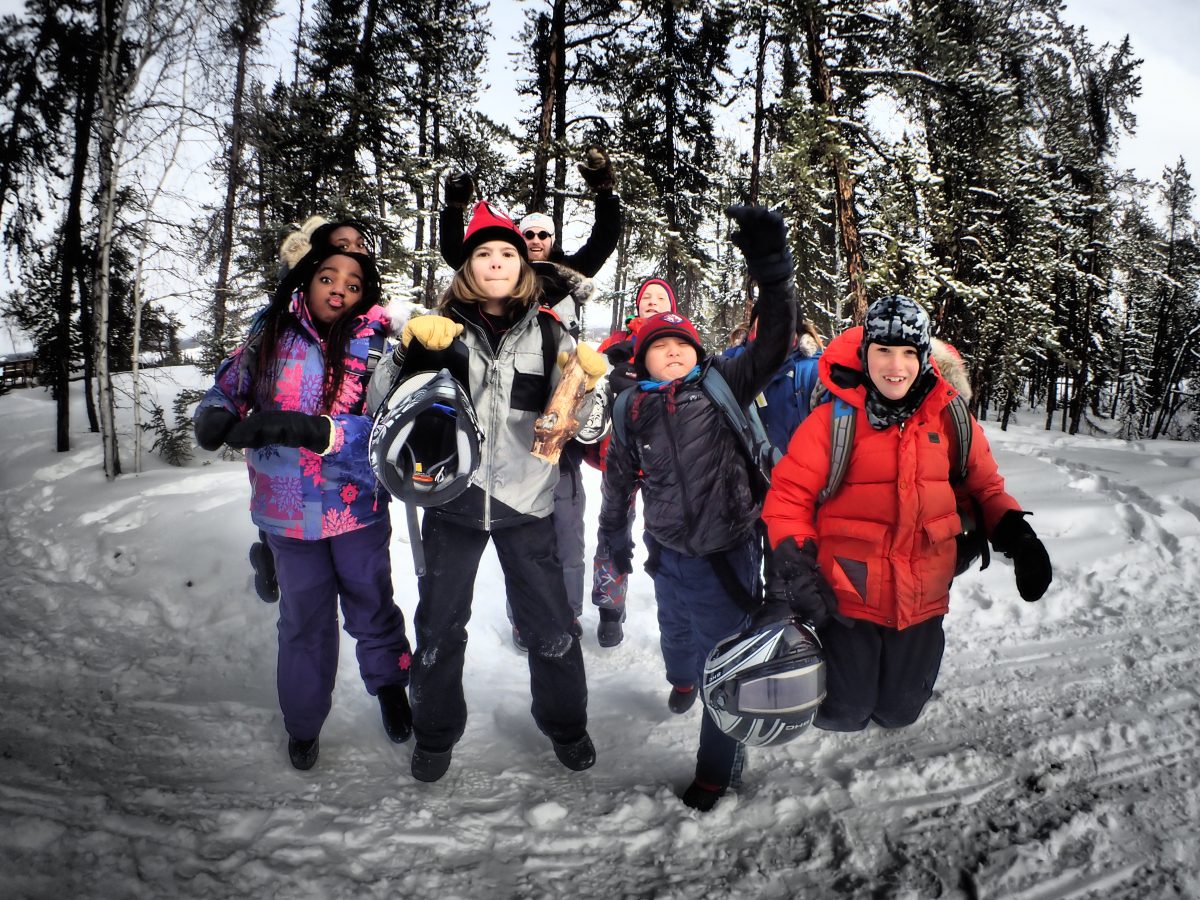 kids jumping at a winter adventure camp