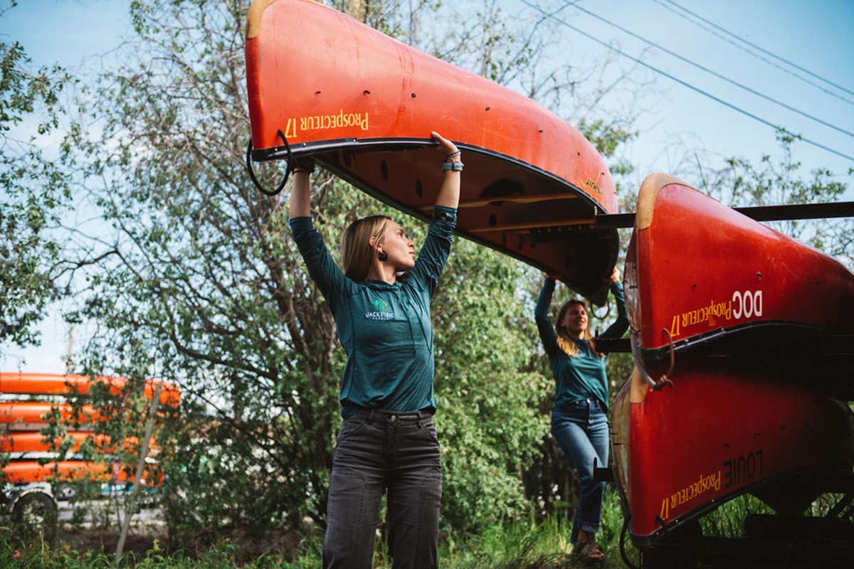 lifting canoes off a trailer in Yellowknife