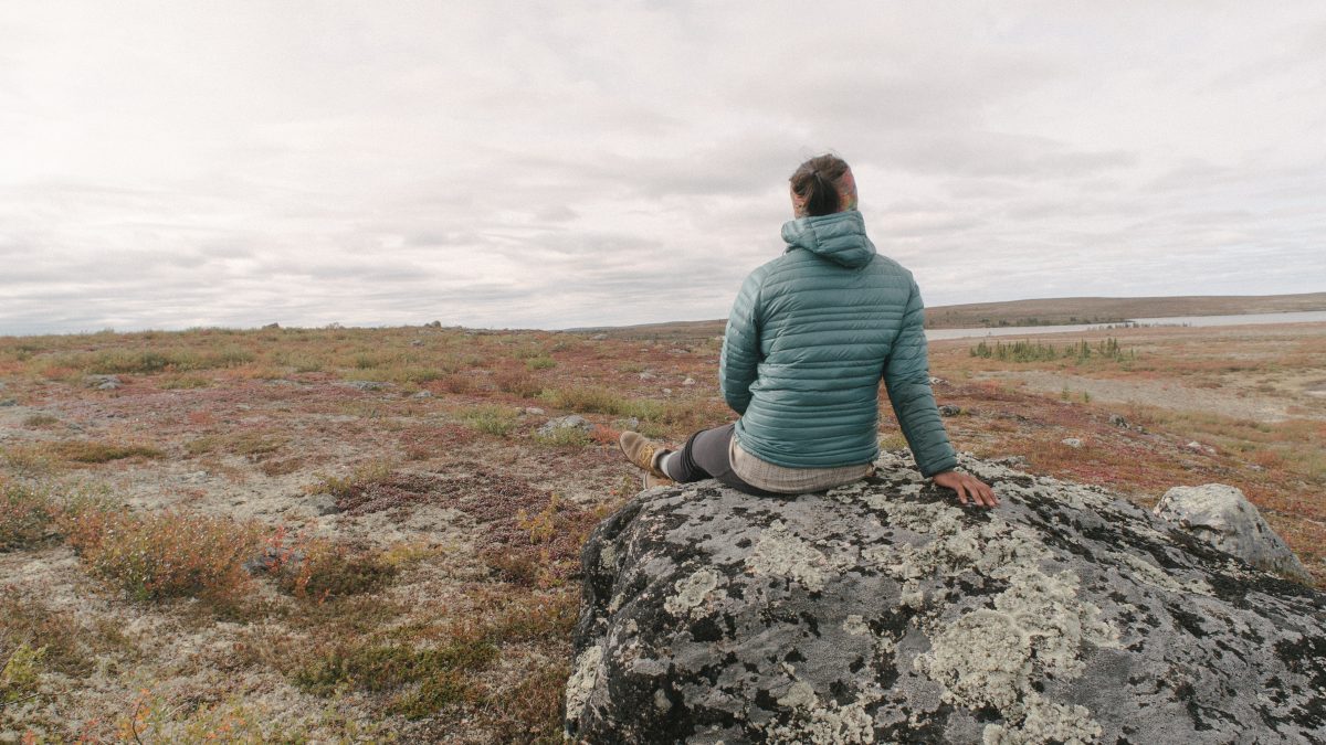 sitting on a boulder on the tundra
