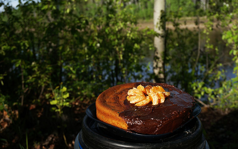 dutch oven cake on a canoe barrel