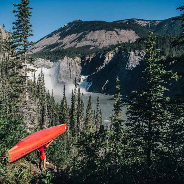 guide portaging a canoe around virginia falls, a map